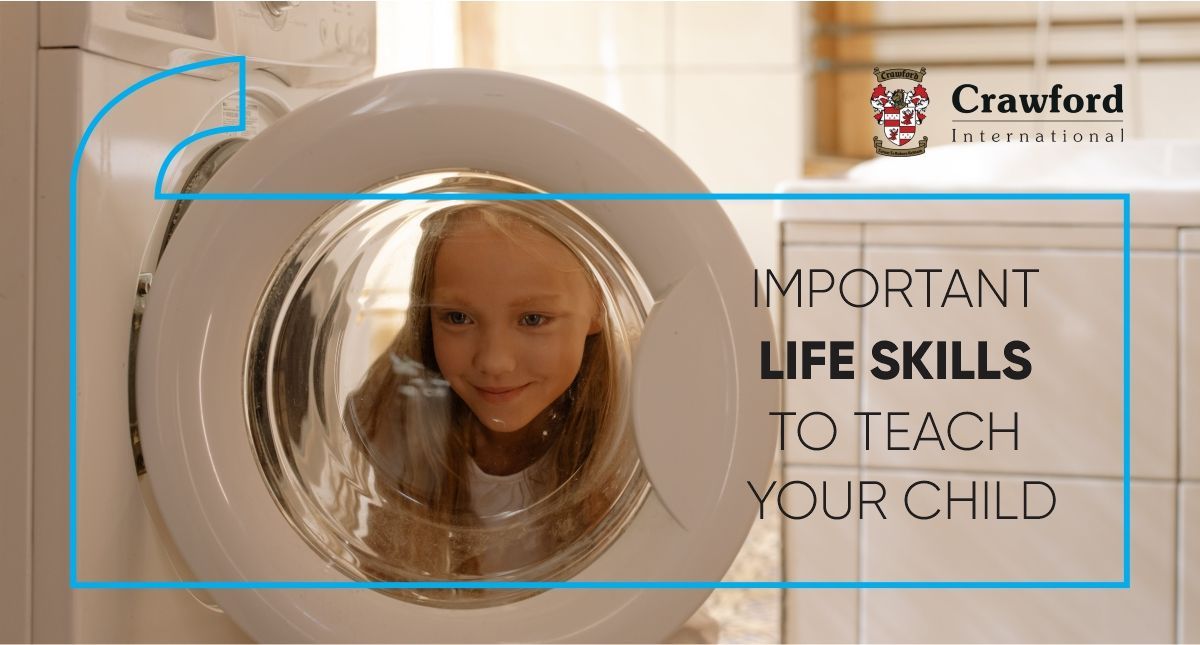 Little girl looking through washing machine door