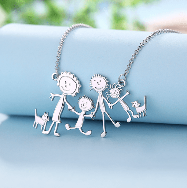 A necklace with a drawing of a family and a cat on it.