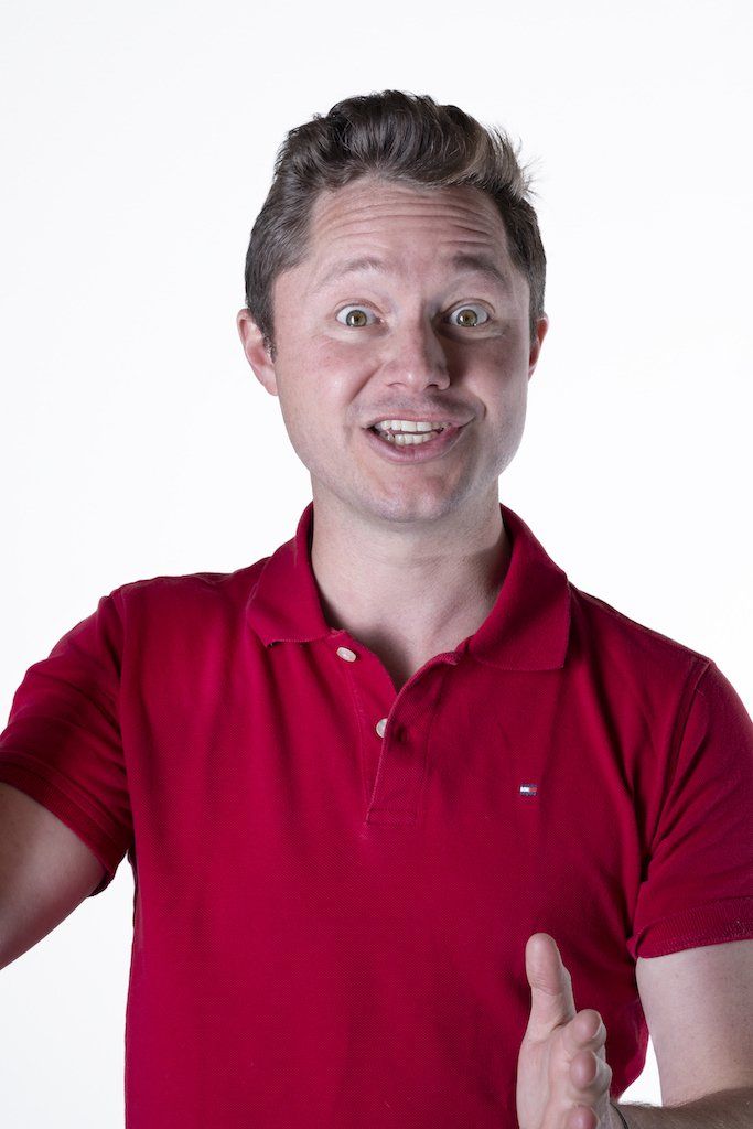 A man in a red polo shirt is giving a thumbs up.