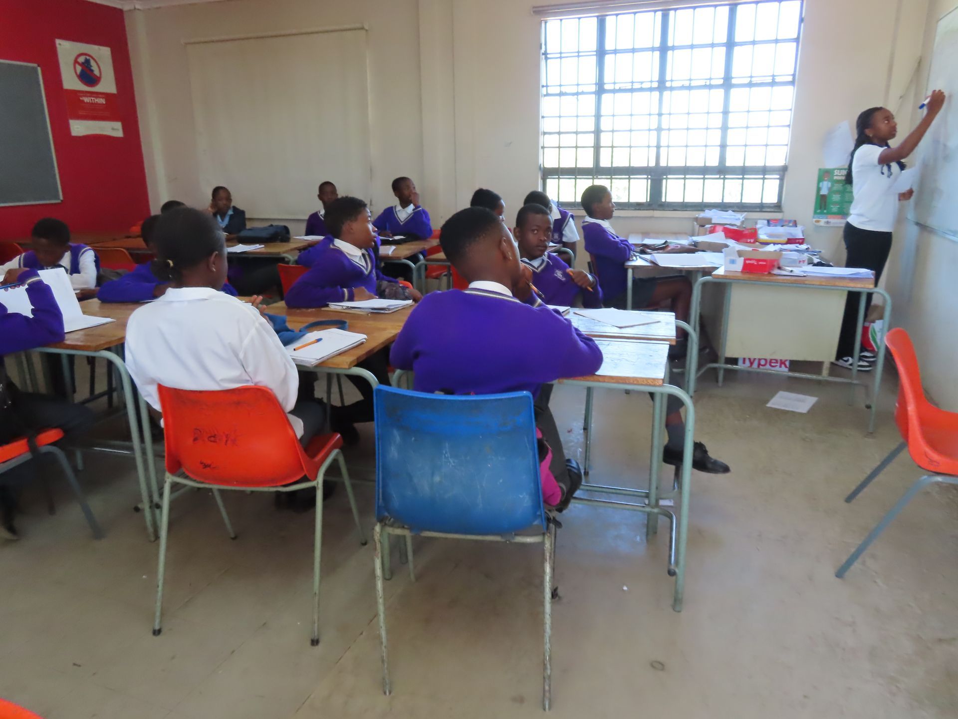 A group of children are sitting at desks in a classroom