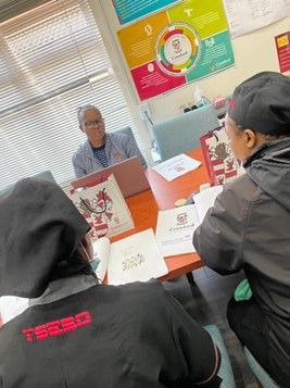 A group of people are sitting around a table in a room.