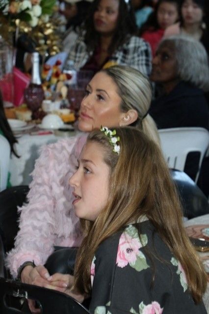 A woman and a girl are sitting at a table