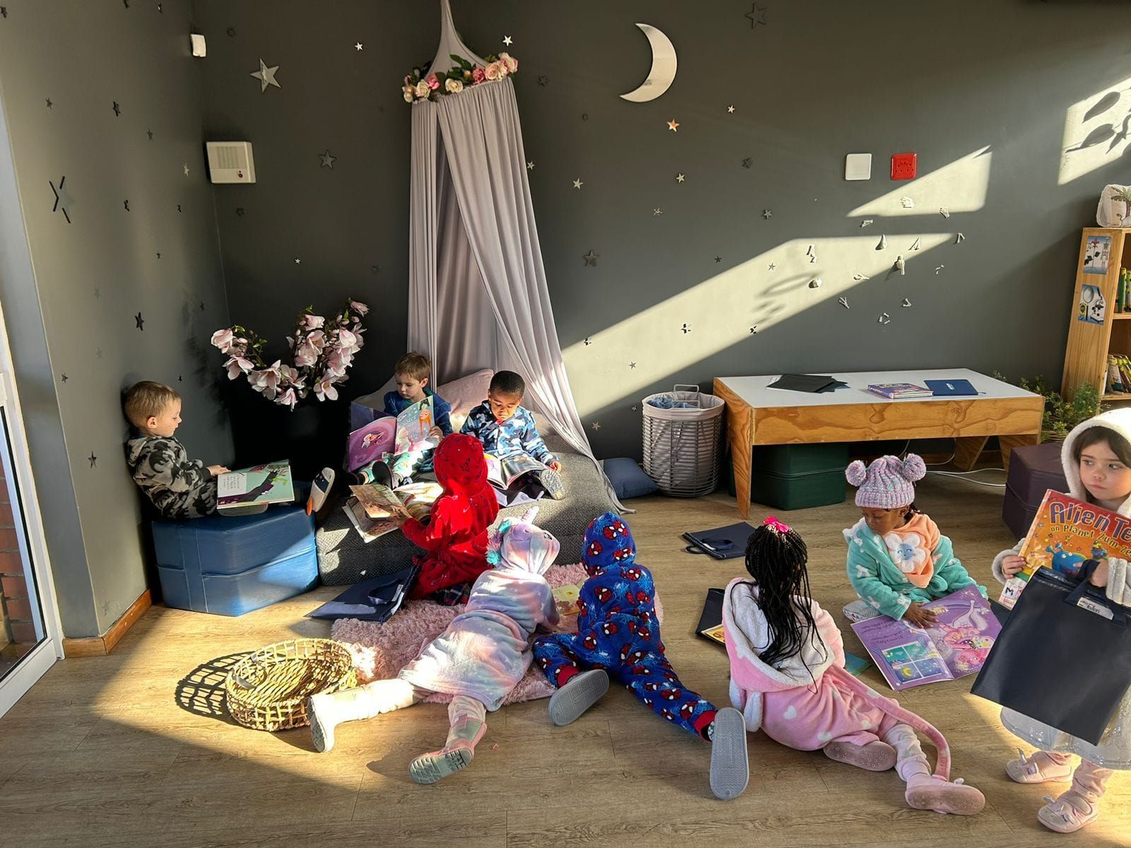 A group of children are laying on the floor in a room.
