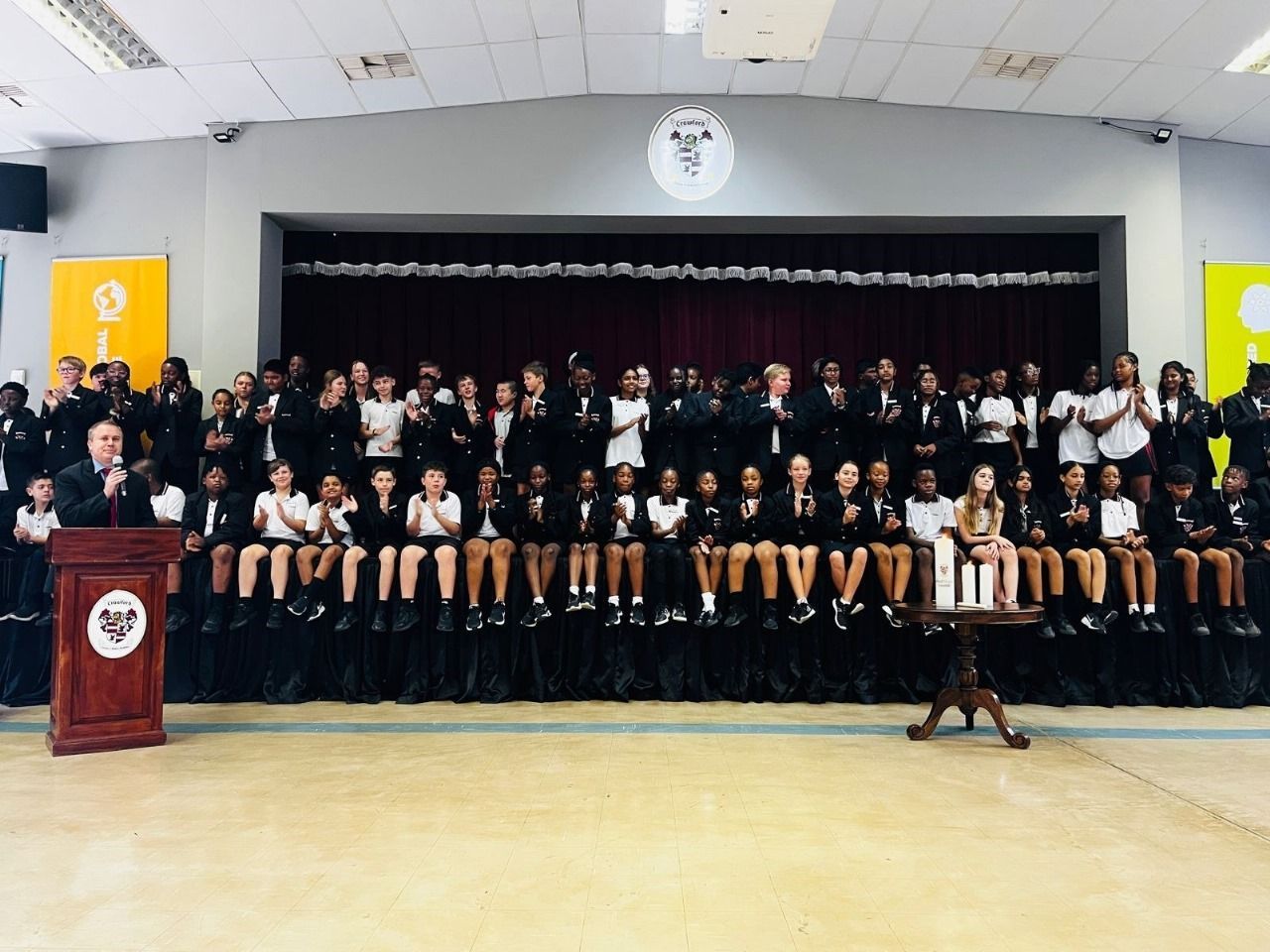 A large group of people standing in front of a podium
