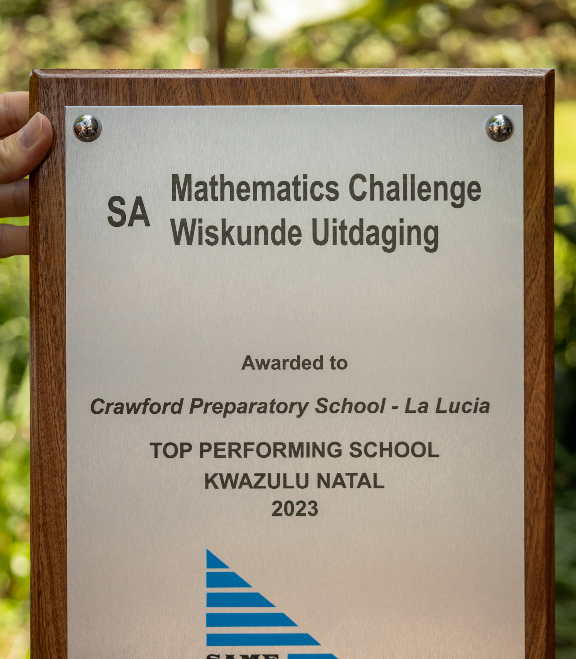 A person is holding a plaque that says mathematics challenge