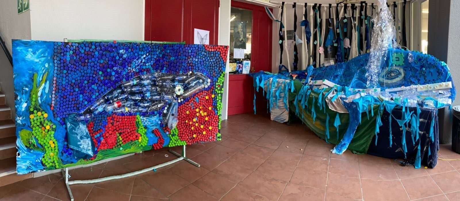 A large painting of a whale is sitting on a table in a room.