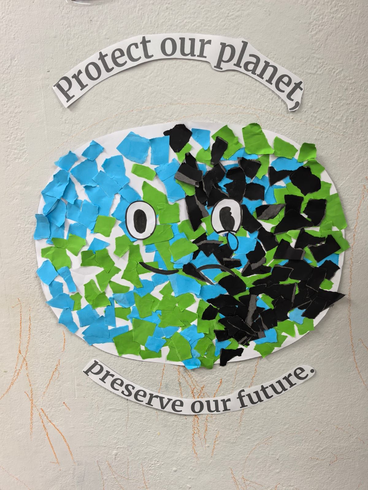 Paper collage of Earth with blue, green, and black pieces; text reads, “Protect our planet, preserve our future.”
