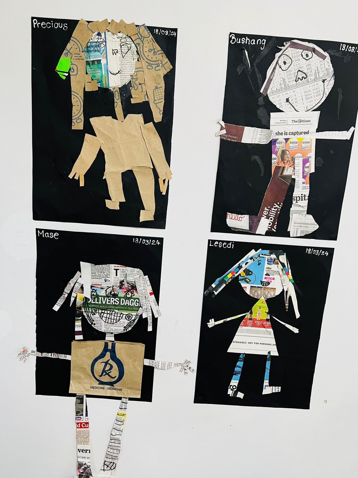 Four children 's drawings of people made out of newspaper