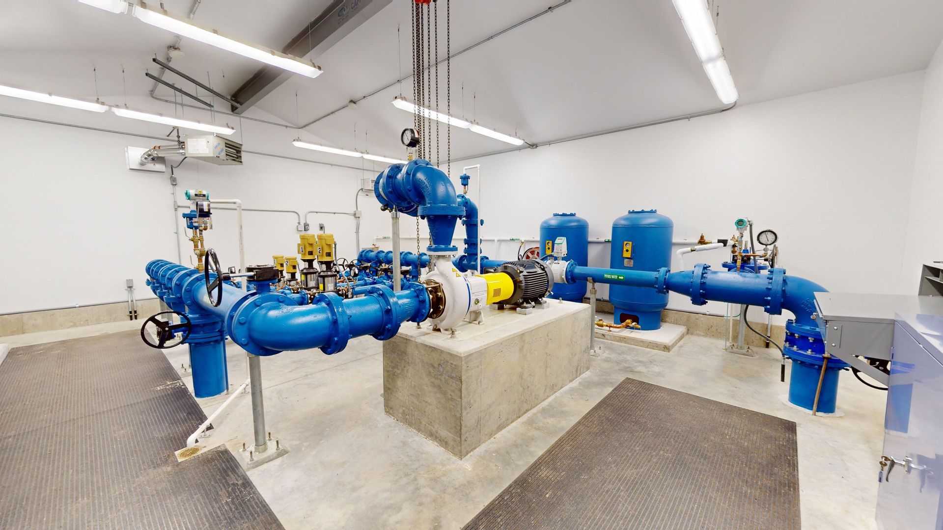A room filled with lots of blue pipes and pumps.