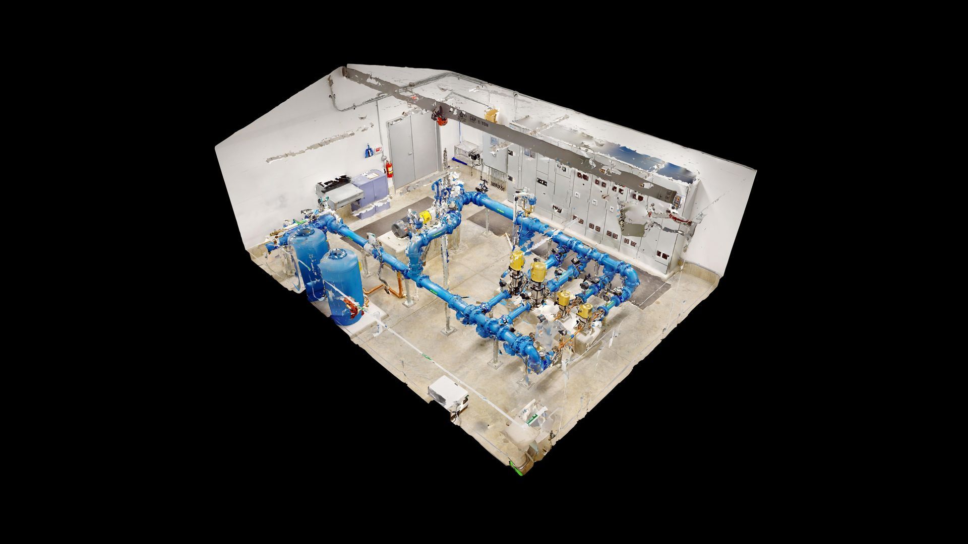 An aerial view of a water pump station with a lot of blue pipes.