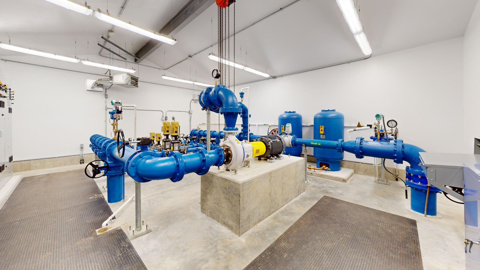 A room filled with lots of blue pipes and pumps.