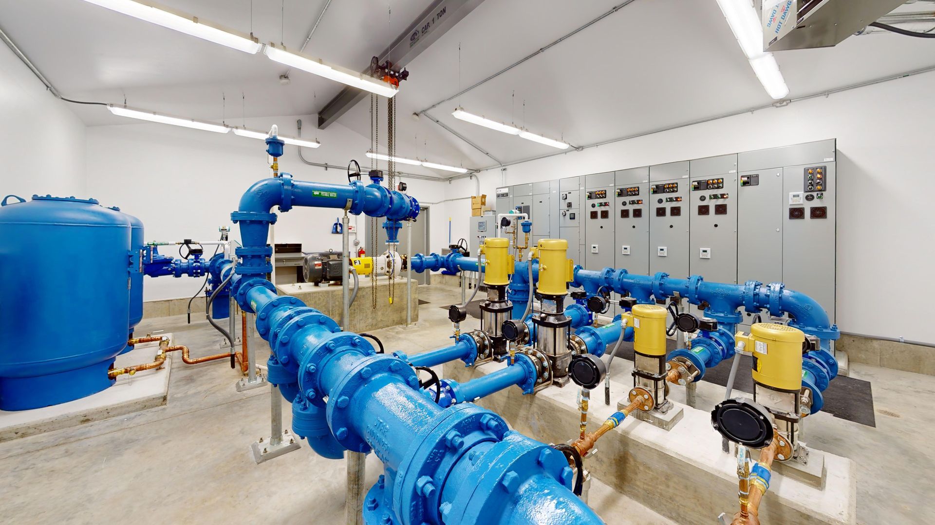 A room filled with lots of blue pipes and pumps.