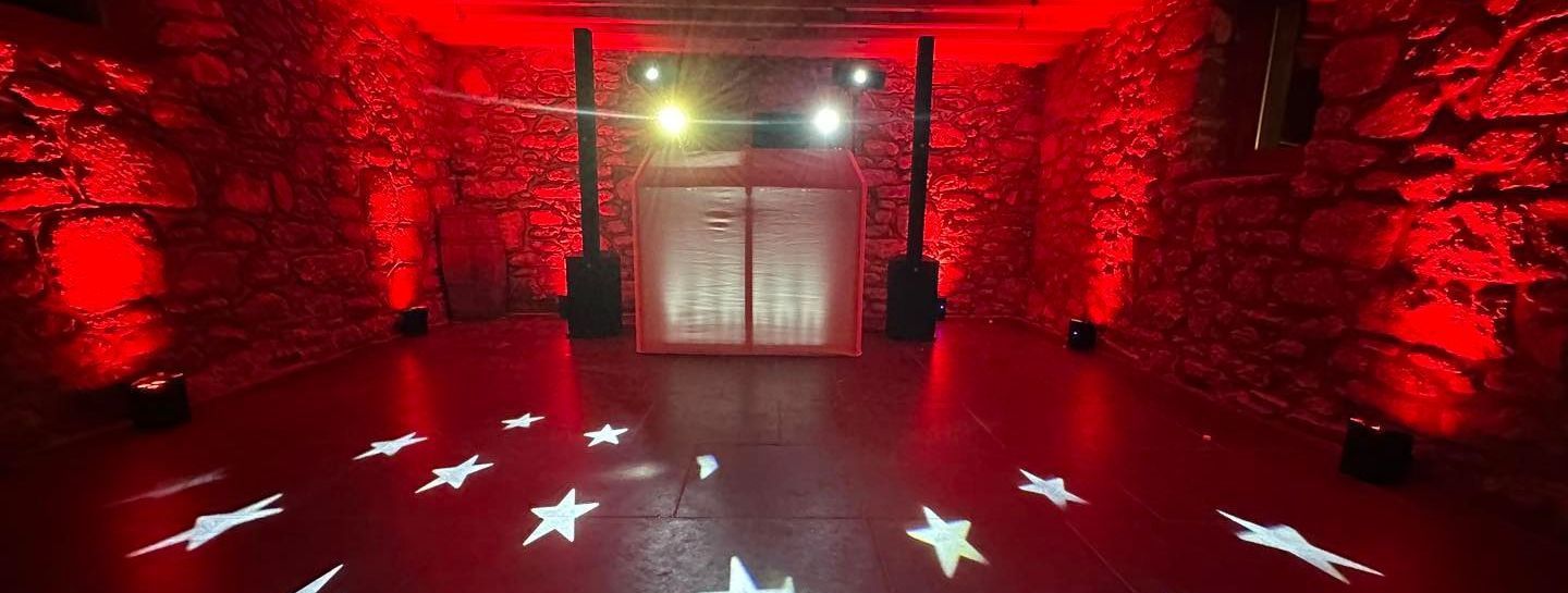 Red-lit room with star patterns on the floor. Stone walls surround a double-door entrance.