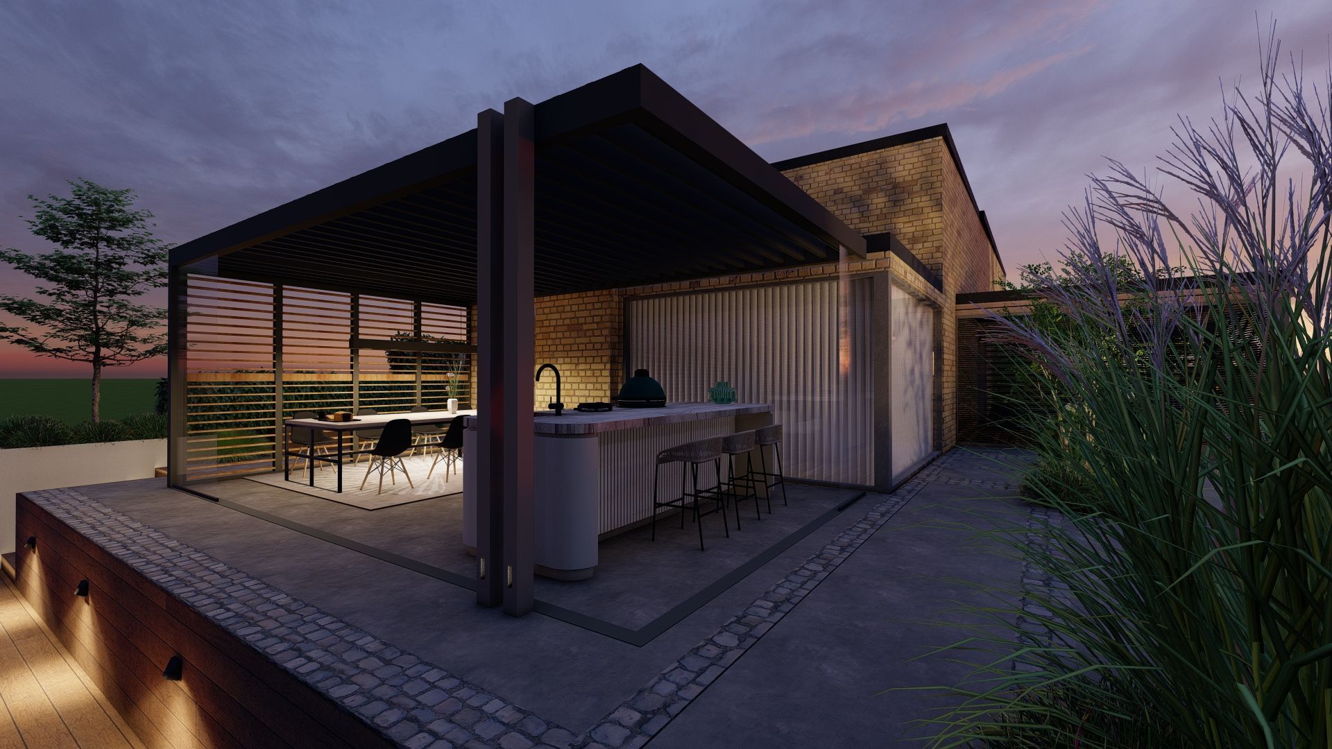 Buitenkeuken en zitgedeelte onder een pergola in de schemering. Grijze muren, donkere pergola en hoog gras.
