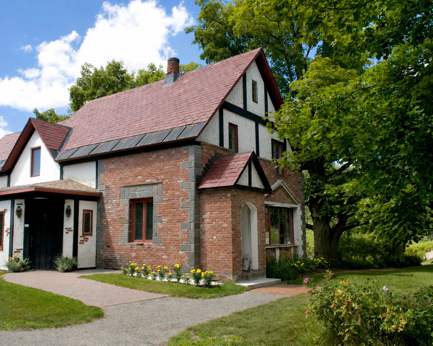 Brick cottage with red roof and garden sign reading “Curtis T…” beside a path