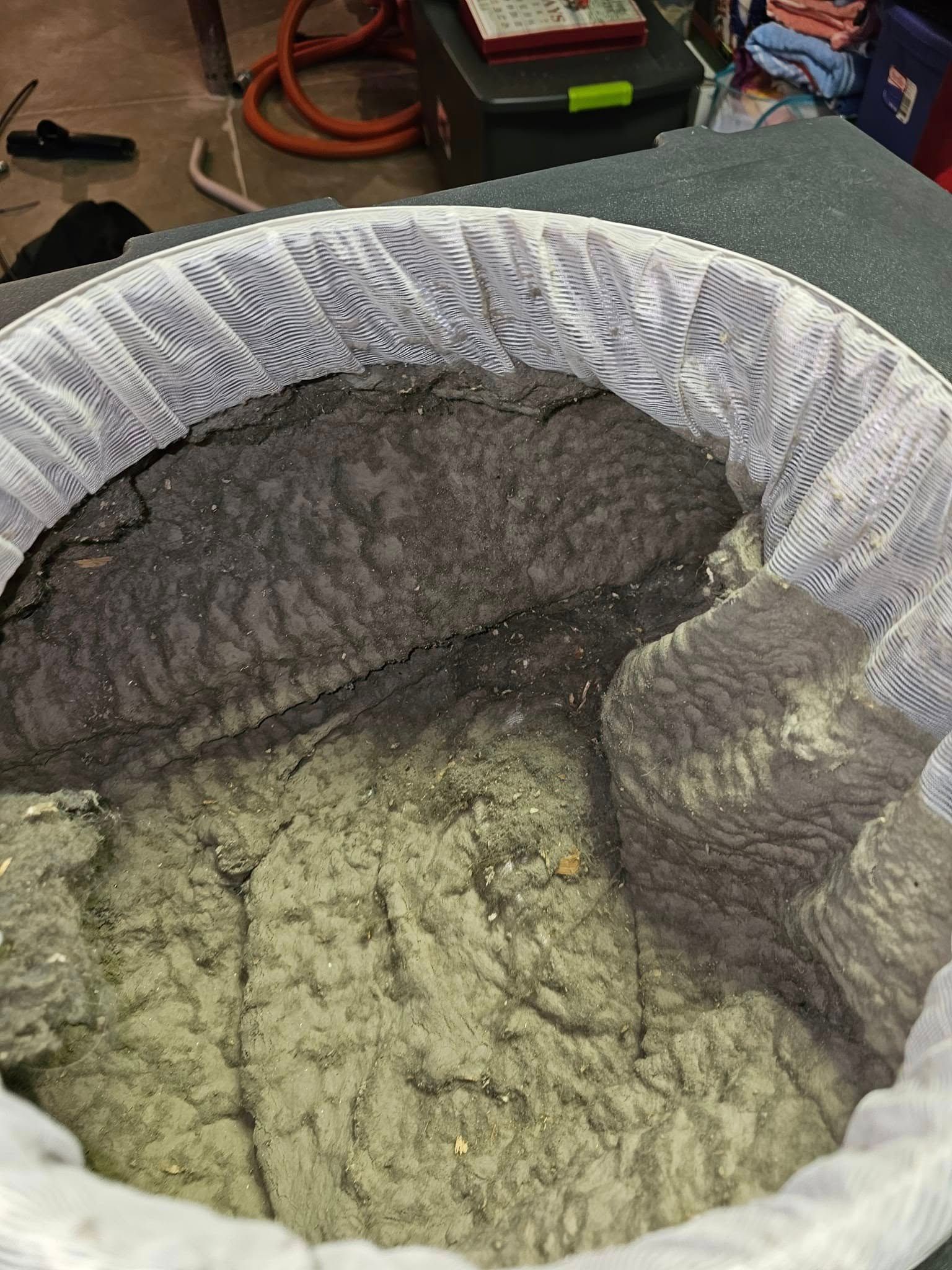 Dirty filter bag filled with heavy dust and debris after an air duct cleaning.