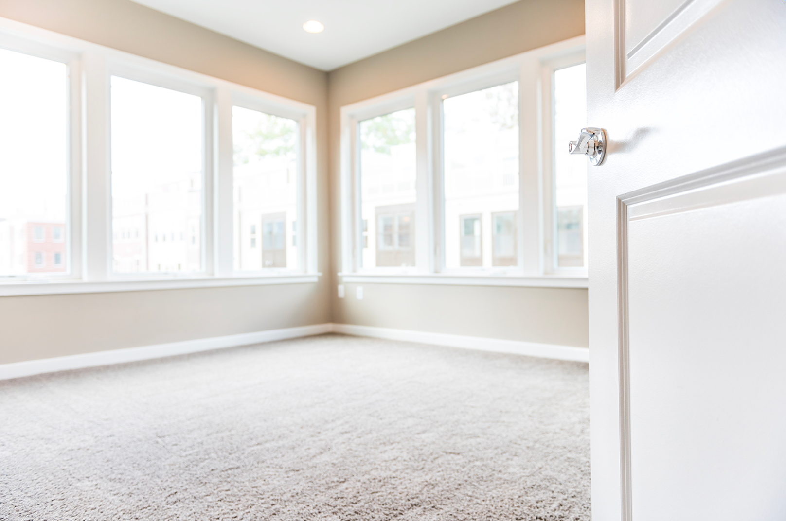 Bright empty room with freshly cleaned residential carpet, showcasing soft texture and refreshed appearance