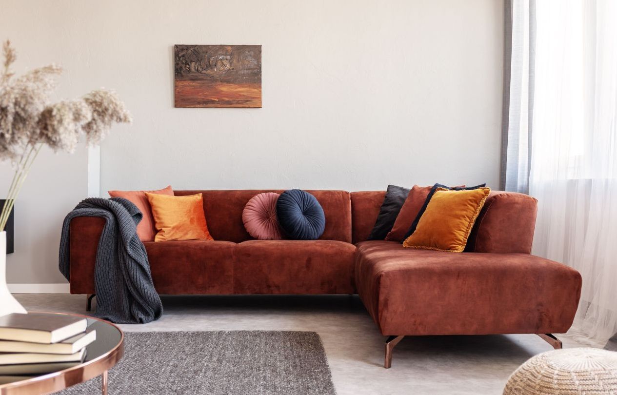 Clean sectional sofa in living room after professional upholstery cleaning, showing refreshed fabric and color