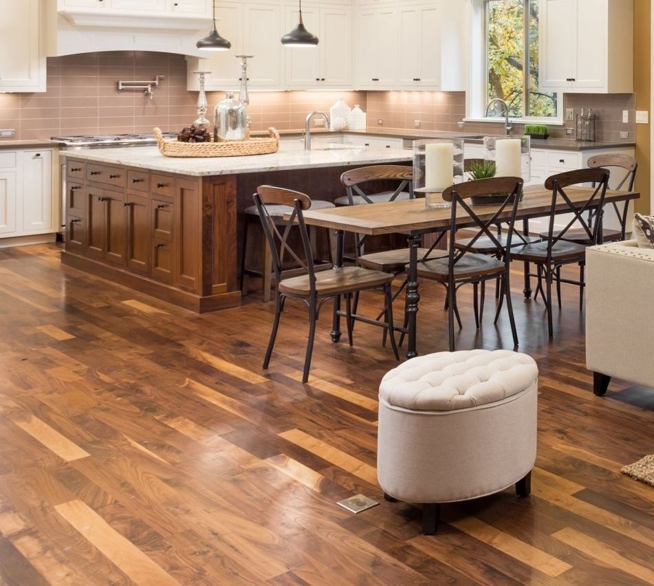 Beautiful residential kitchen with polished hardwood floors after professional floor cleaning.