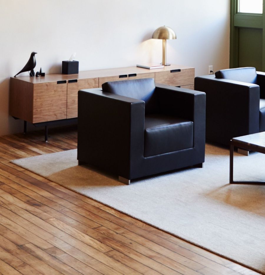 Clean office seating area with area rug and hardwood floor after professional floor cleaning