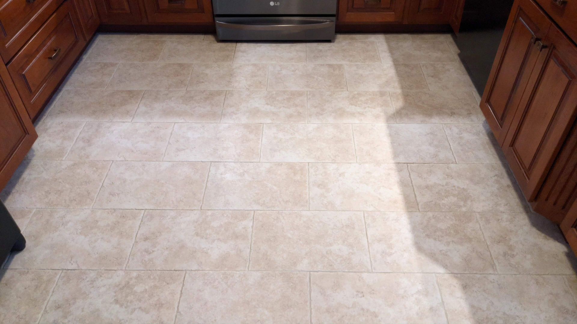 Kitchen tile floor after professional tile and grout cleaning with uniform color and refreshed grout lines