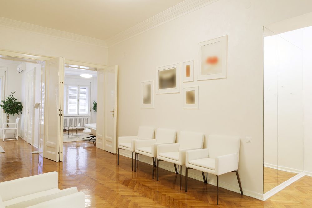 Clean commercial waiting area with hardwood floors and seating after professional floor cleaning service