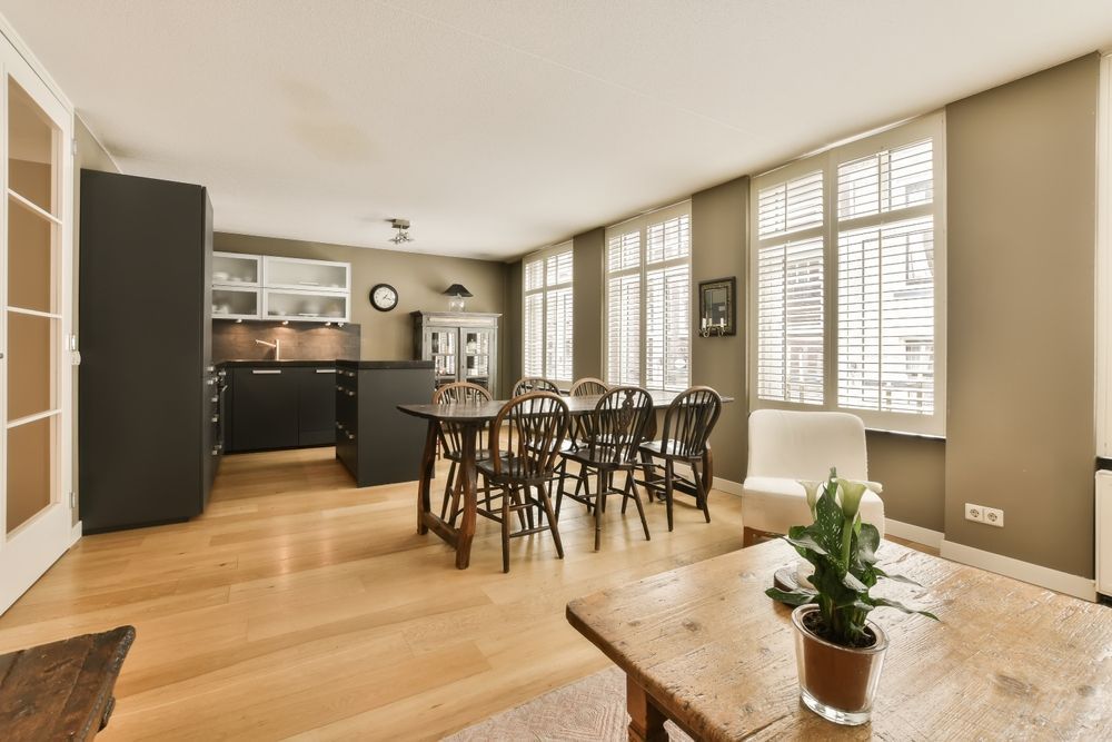Open living and dining area with freshly cleaned hardwood floors, showcasing natural shine and warm finish
