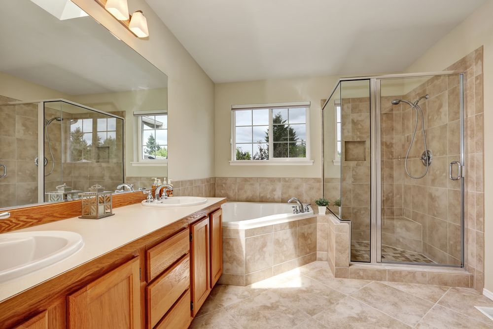 Clean bathroom with freshly cleaned tile and grout floors, shower, and vanity after professional floor care service