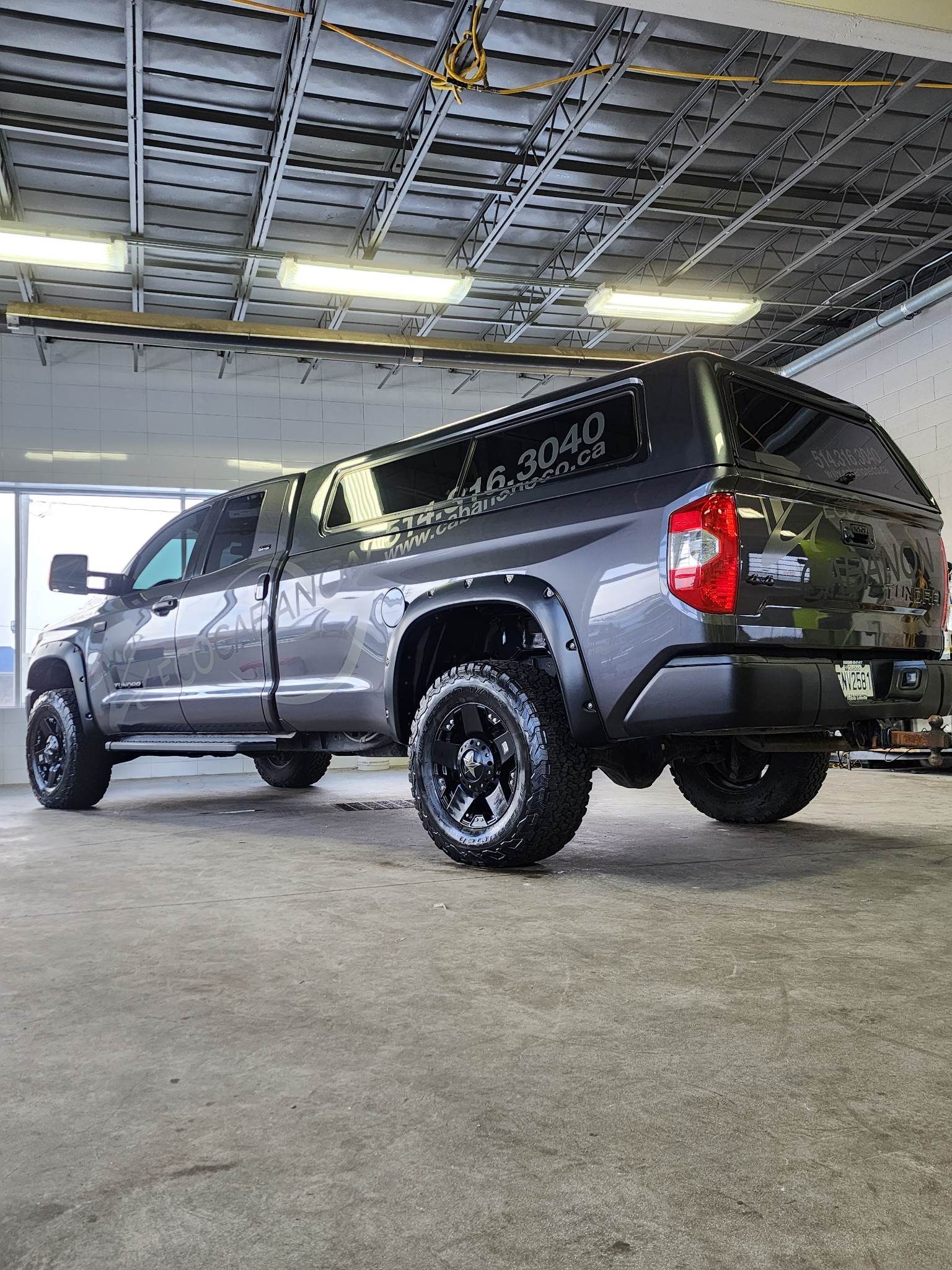 A toyota tundra is parked in a garage.