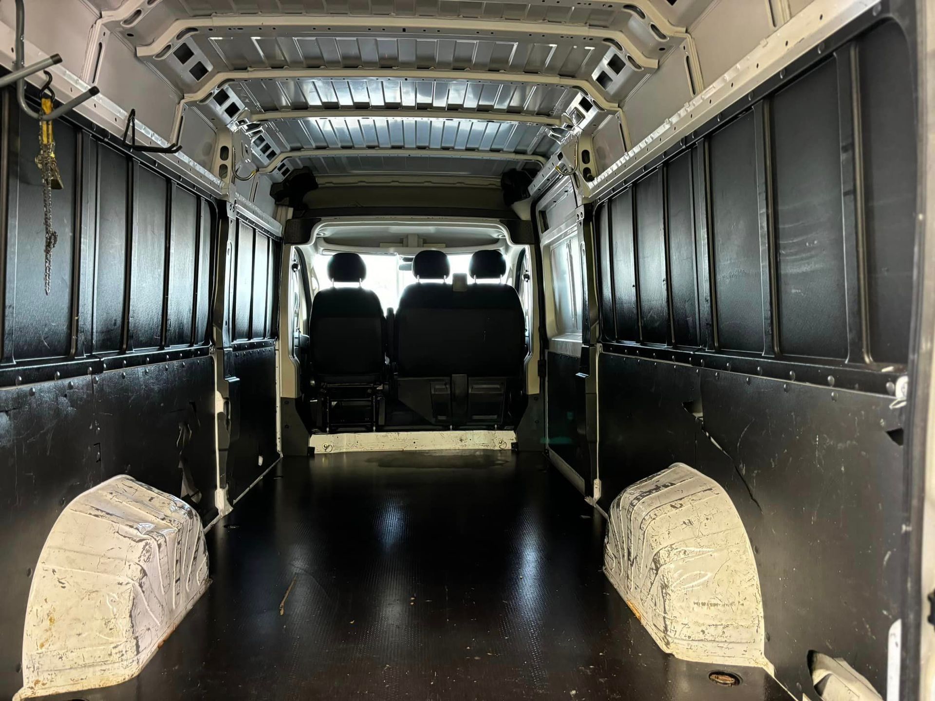 The inside of an empty van with a wooden floor