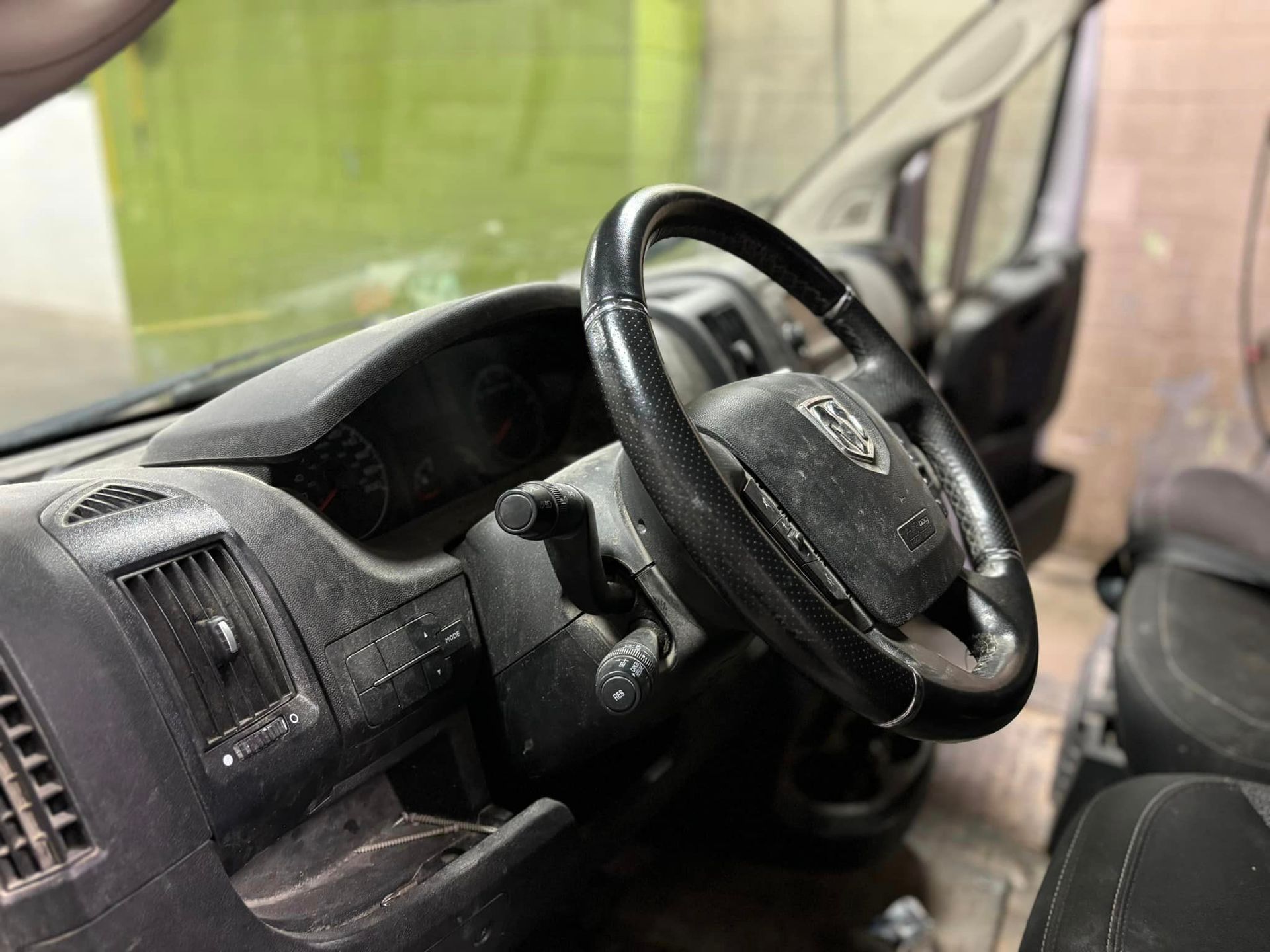 A close up of a steering wheel in a car