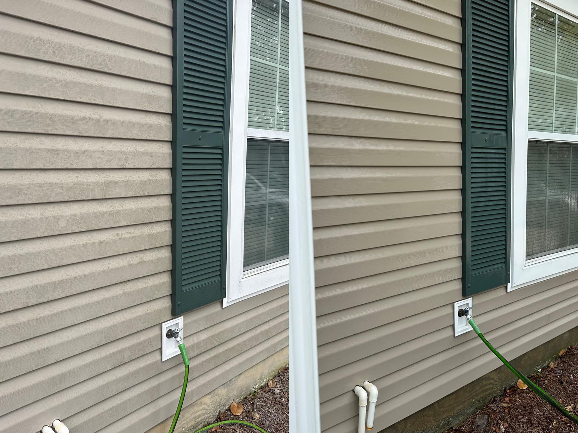 Two green garden hoses are connected to outdoor spigots on the side of a house with tan siding and green shutters.