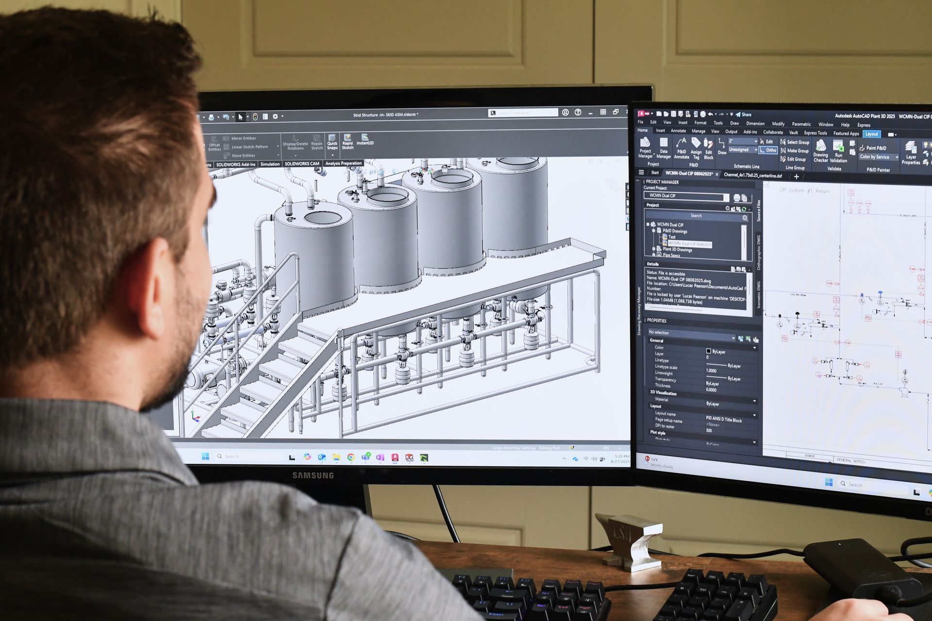 Man working on a 3D model and technical drawings on dual computer monitors.