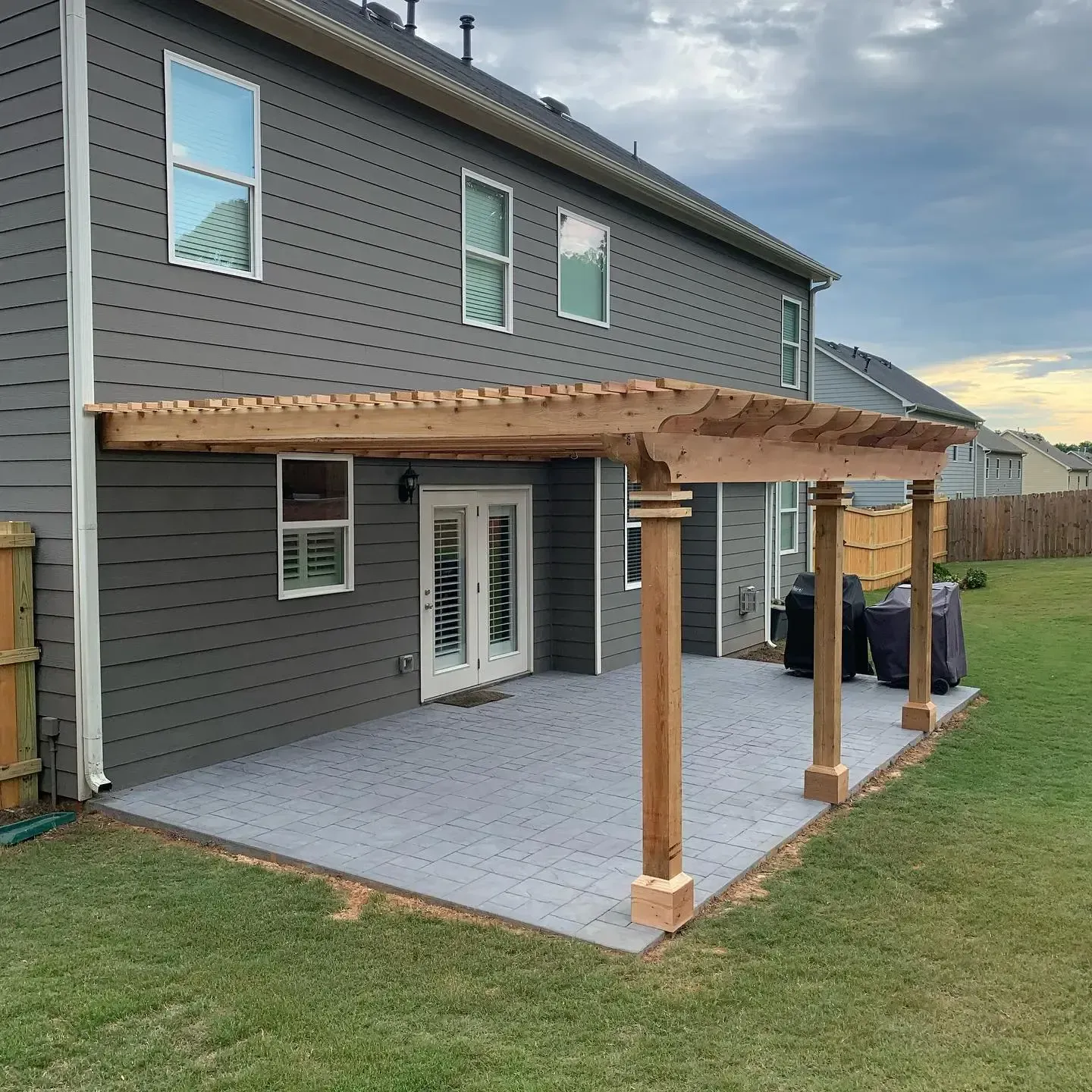 After installing wooden patio pergola and paver stone flooring.