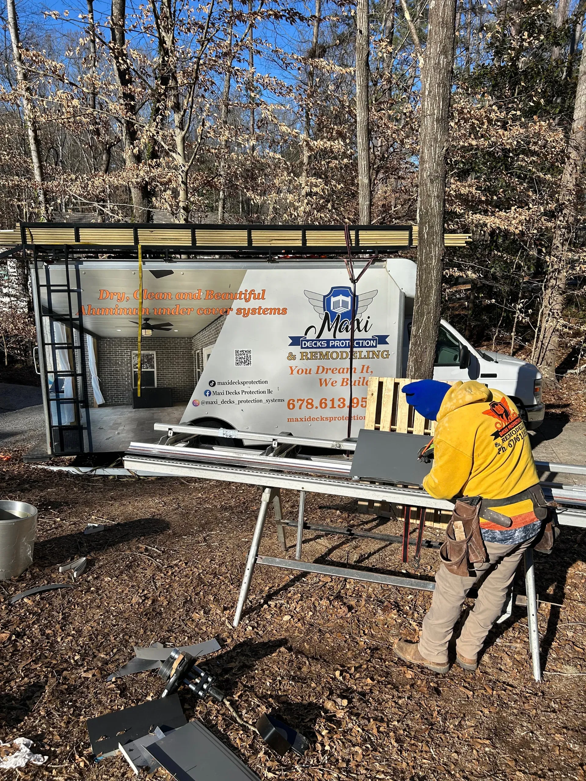 Maxi Decks Protection work truck and employee at under deck ceiling installation job-site.