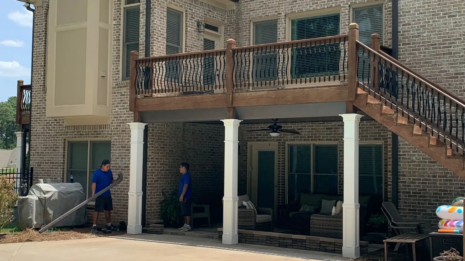 Maxi Decks Protection employees cleaning up after installing the under-deck ceiling.