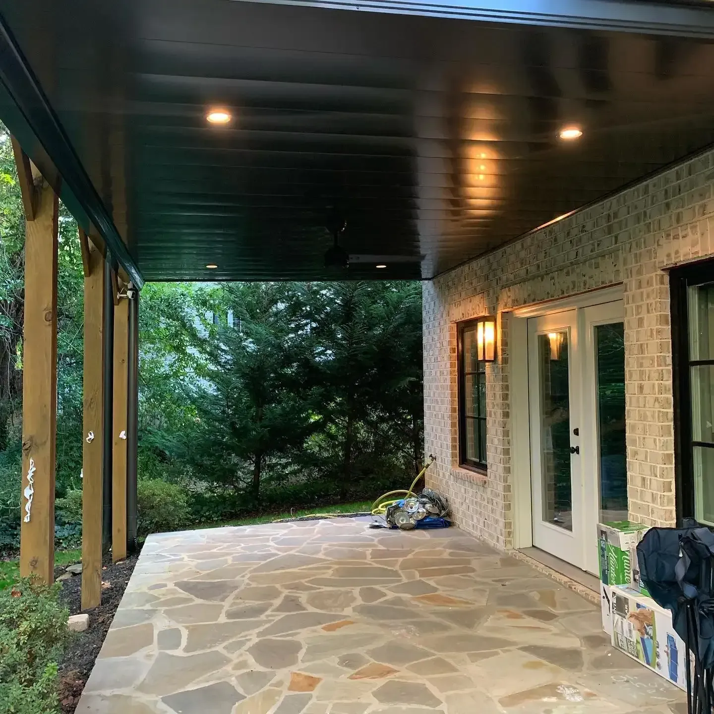 A picture of an aluminum under-deck system that includes lighting and hardscape design.