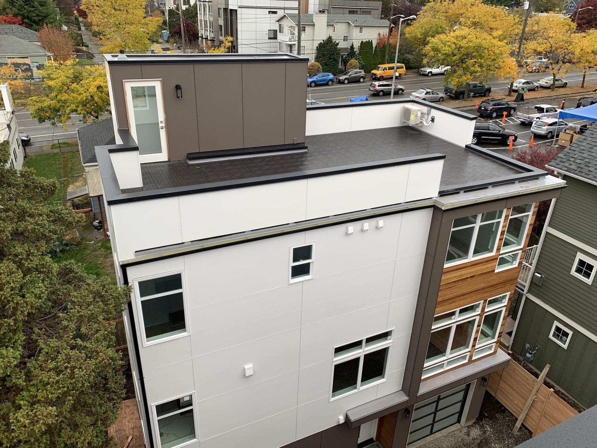 An aerial view of a building with a flat roof and a lot of windows.