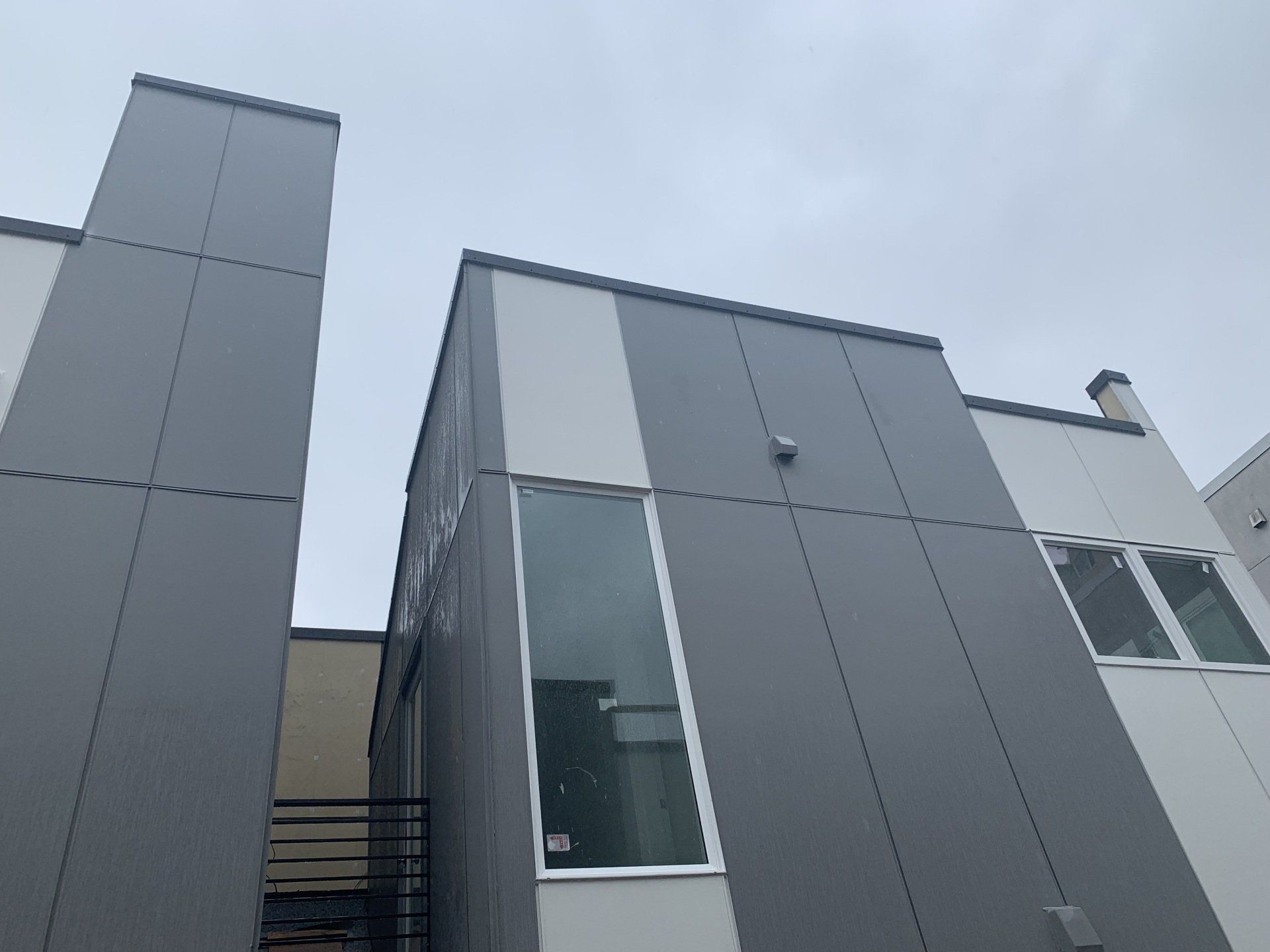 A gray and white building with a lot of windows