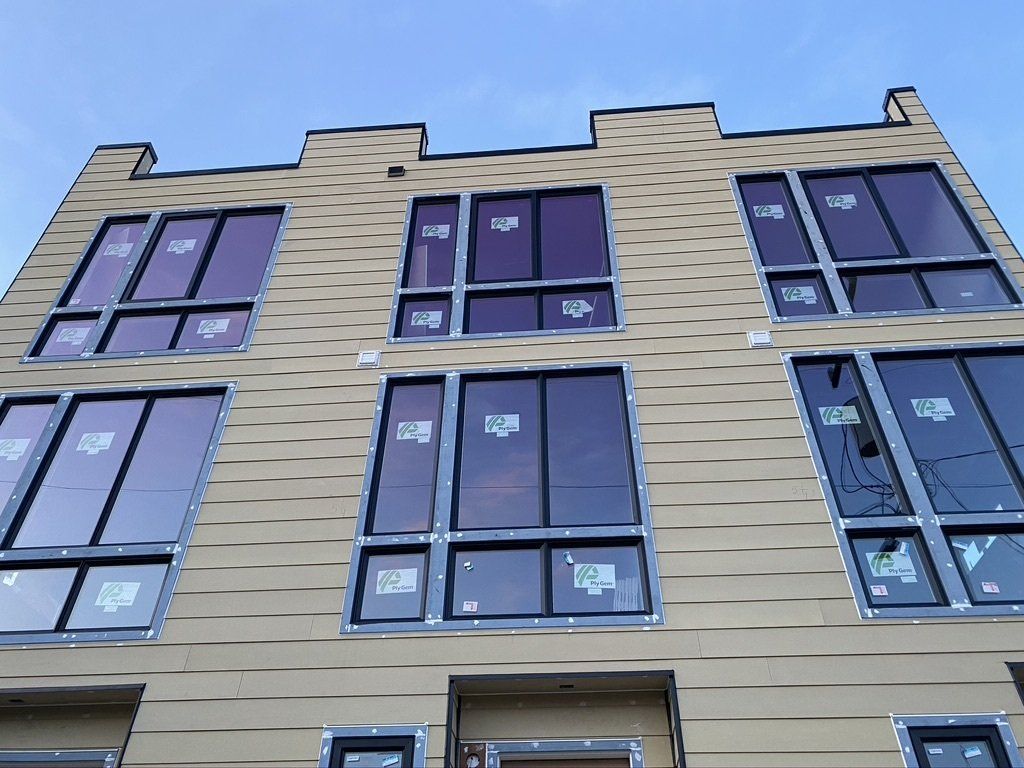 A building with a lot of windows and a blue sky in the background