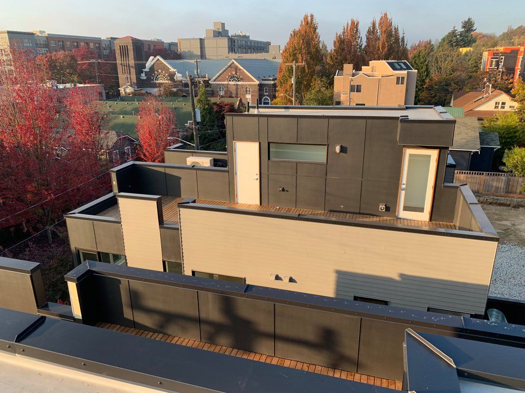 An aerial view of a house with a balcony on the roof.