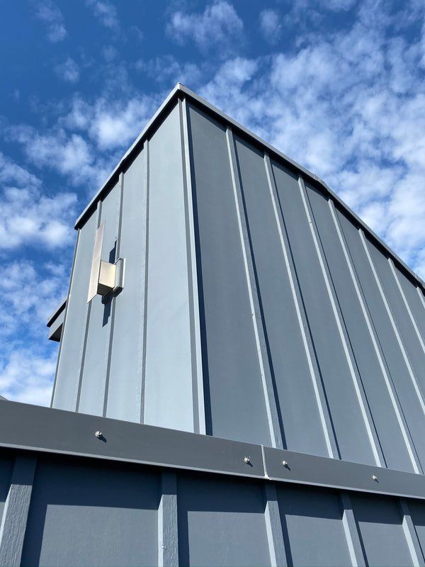 A gray building with a blue sky in the background