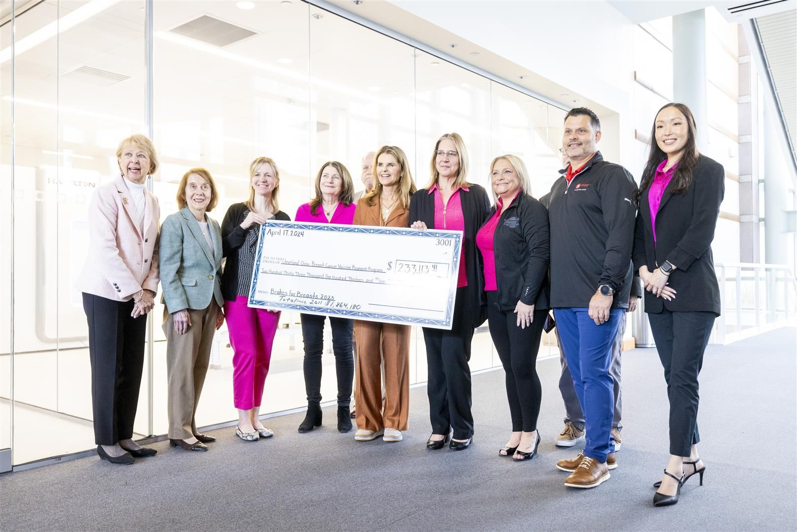 Group posed around large check at 2023 Check Presentation | Brakes For Breasts
