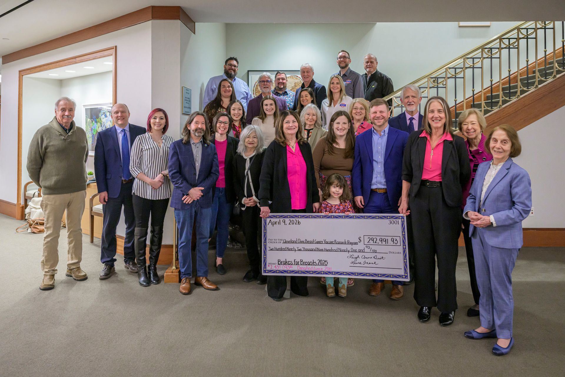 Research team posed around large check at 2023 Check Presentation | Brakes For Breasts
