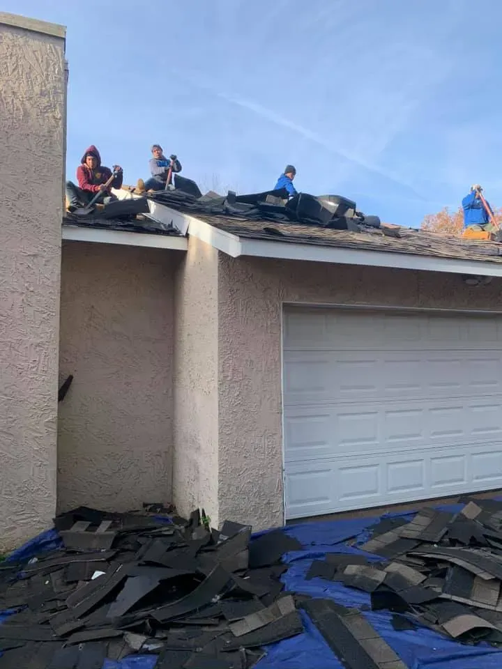 Workers Working On Garage Roof