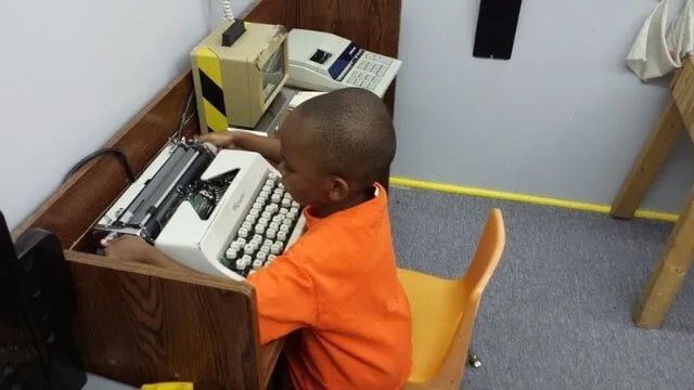 Boy Playing With Typewritter — York, PA — Sunshine Christian Daycare / Learning Center