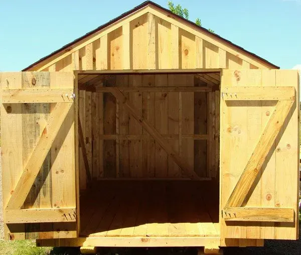 Wooden shed with open double doors.