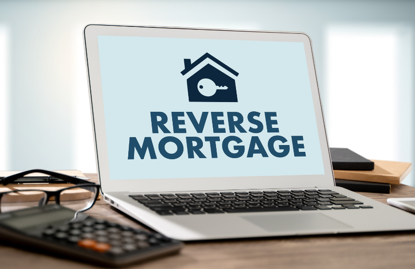 A laptop computer is open to a screen that says `` reverse mortgage ''.