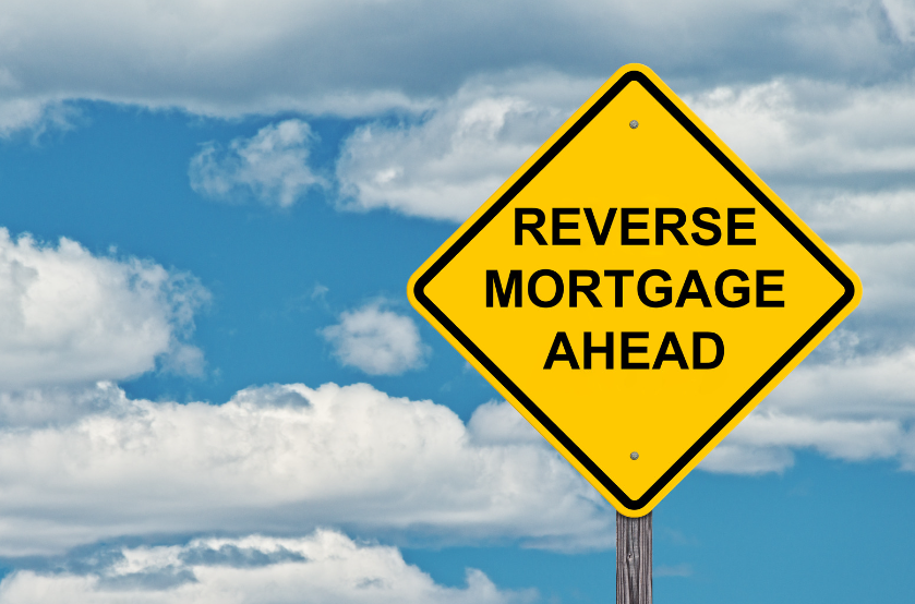 A yellow sign that says reverse mortgage ahead