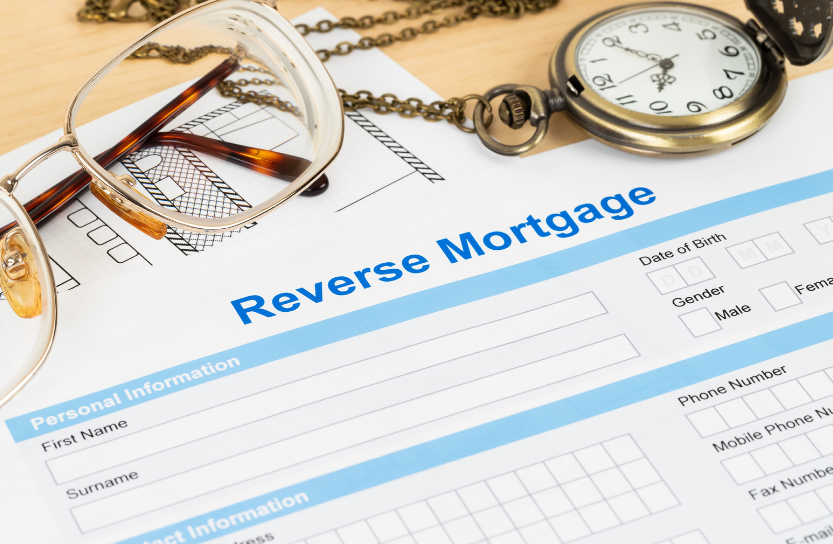 A reverse mortgage form with glasses and a pocket watch on it